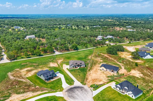 This view shows you the size of the lot, the green grass and fence of the property. This home also has a small retaining wall done near the garage. Move in and enjoy!! | Image 34
