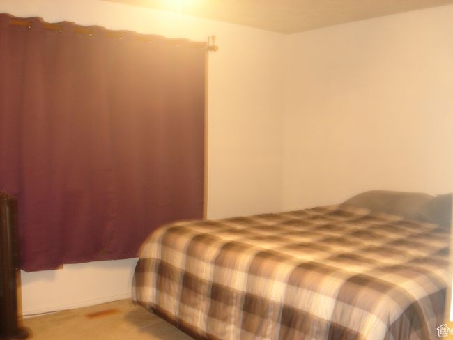 Bedroom featuring light colored carpet | Image 11