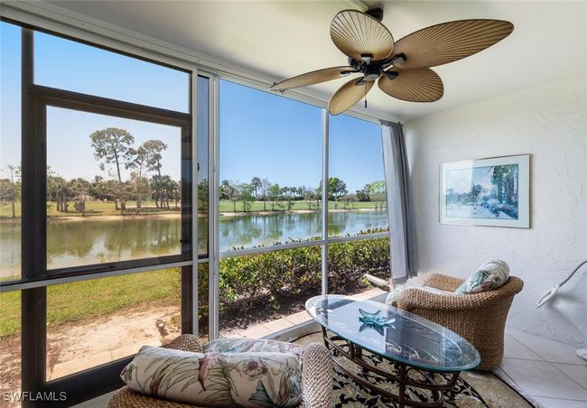 Sunroom / solarium with a ceiling fan and a water view | Image 17