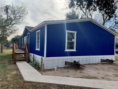 View of property exterior with a deck | Image 1