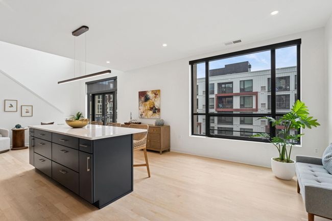 Natural light pours in through oversized windows, highlighting the airy, open-concept layout that feels both grand and inviting. | Image 10