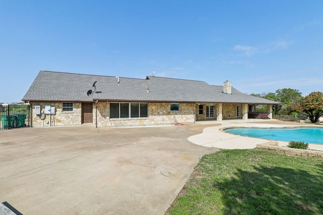 View of swimming pool featuring a fenced in pool, a lawn, fence, and a patio area | Image 31