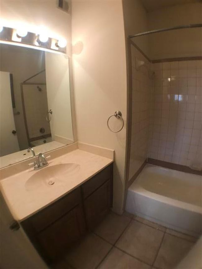 Bathroom featuring vanity, visible vents, tile patterned flooring, and shower / bath combination | Image 9