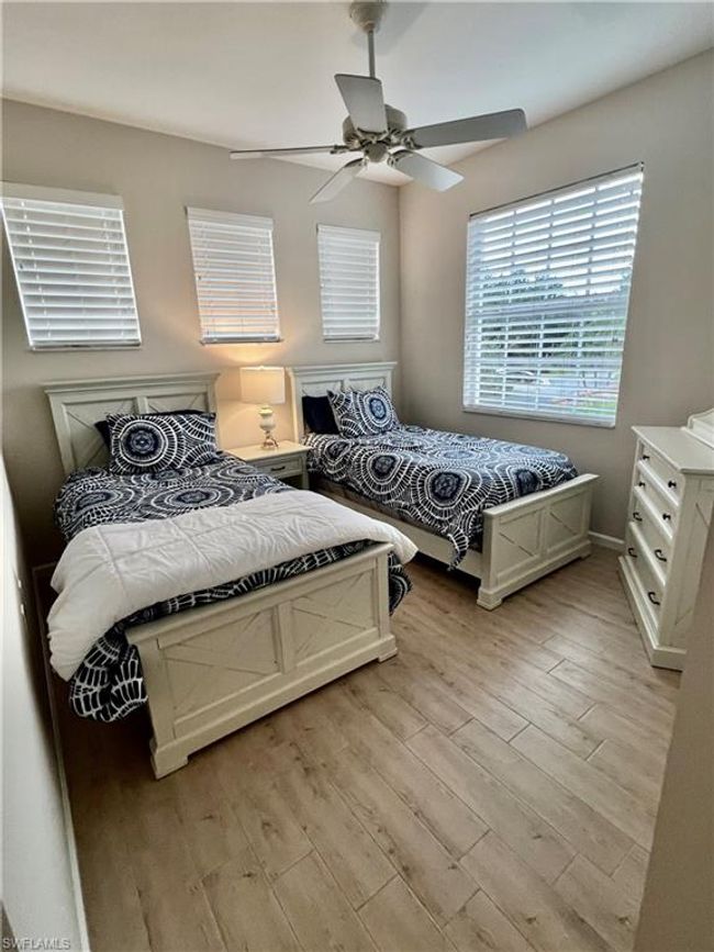 Guest bedroom #2 has twin beds before furniture was moved | Image 32