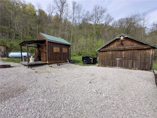 View of outdoor structure featuring an outdoor structure and a forest view | Image 8