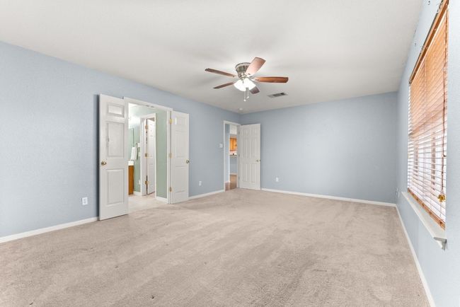 Unfurnished bedroom featuring visible vents, a ceiling fan, carpet, and baseboards | Image 18