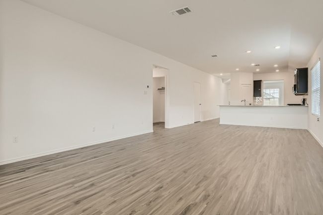 Unfurnished living room with light wood-style floors, recessed lighting, and baseboards | Image 5