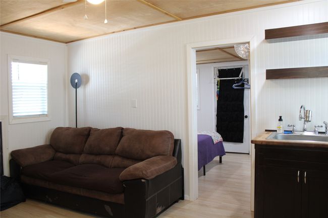 Living area with light wood-style flooring and ceiling fan | Image 4