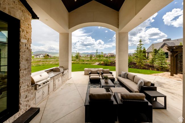 View of patio / terrace featuring exterior kitchen, an outdoor hangout area, and a mountain view | Image 55