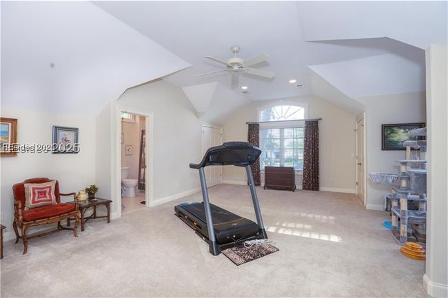 Upstairs is the BONUS bedroom being used for TV viewing and fitness. It has an en-suite full bathroom as well as 2 walk-in California-style closets and access to the walk-in full house attic storage. | Image 45