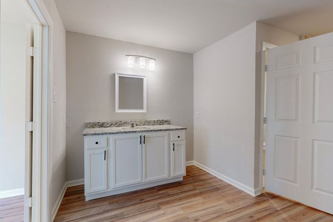 Bathroom featuring vanity and hardwood / wood-style floors | Image 26