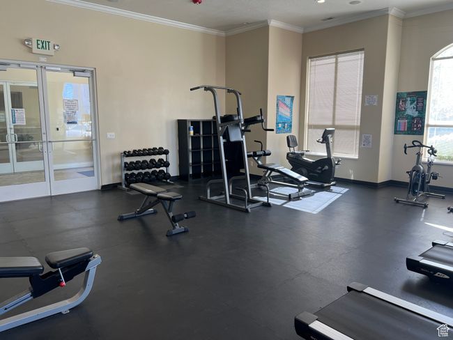 Workout area featuring crown molding, baseboards, and french doors | Image 24