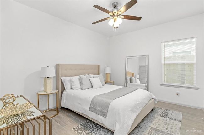 Bedroom featuring light wood-type flooring and a ceiling fan | Image 7