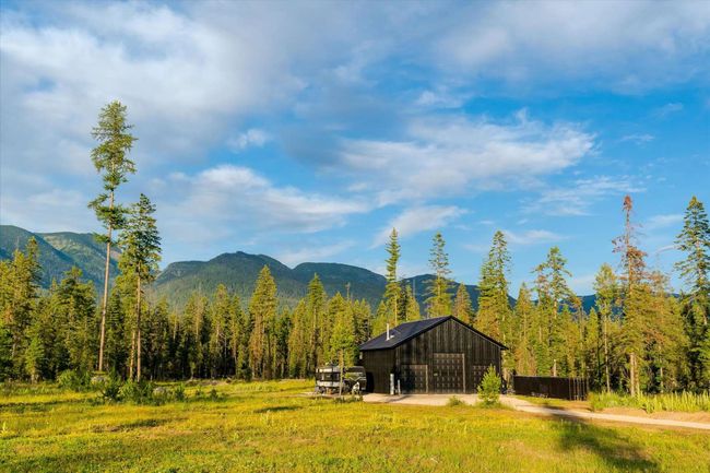 View of mountain backdrop featuring a heavily wooded area | Image 56