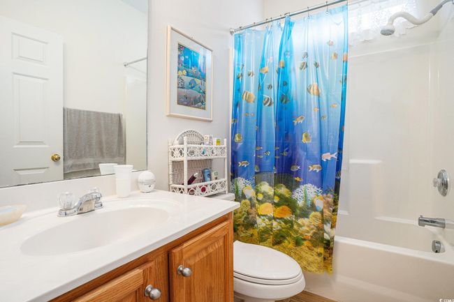 Full bath featuring vanity and shower / bath combo with shower curtain | Image 18