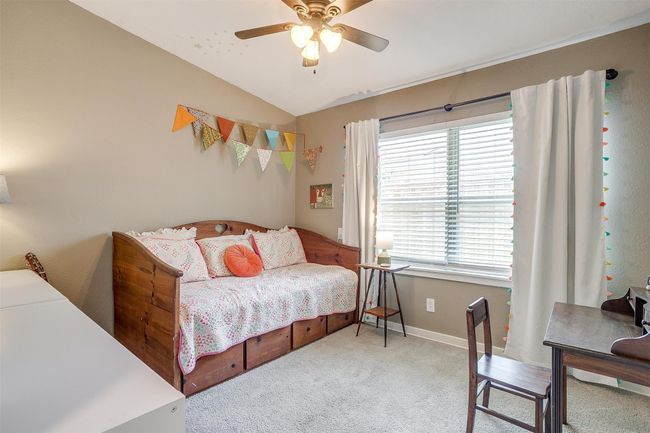 Carpeted bedroom with multiple windows, vaulted ceiling, and a ceiling fan | Image 18