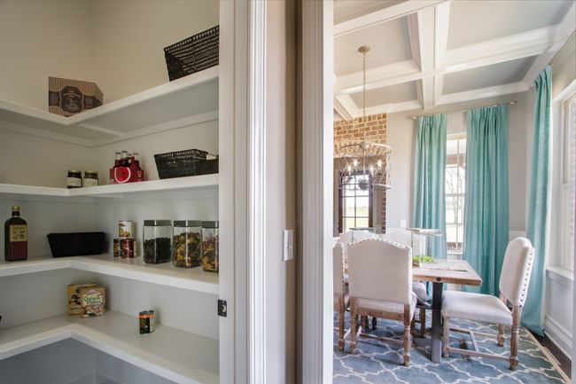 The butler's pantry includes a large pantry with wood shelves. | Image 14