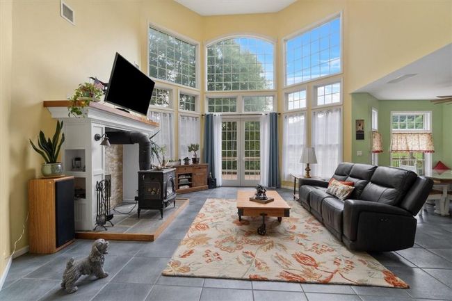 30' Wall of Windows w/8' French Door leading to deck. 9' octagonal turret w/5 windows (not in view) | Image 10