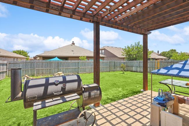 Fenced backyard with a pergola | Image 29