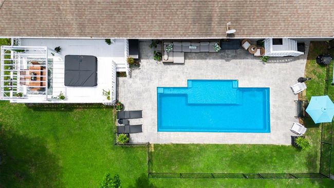 Outdoor entertainer’s paradise featuring new pool, inviting al fresco dining area, cool shaded patio, and relaxing hot tub — perfect for hosting or unwinding in style | Image 7