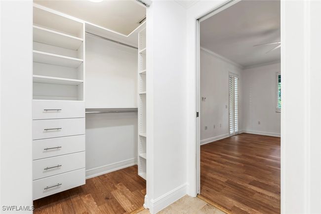 Walk in closet featuring hardwood / wood-style floors and ceiling fan | Image 12