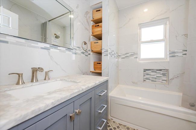 Bathroom featuring vanity and shower / tub combination | Image 15