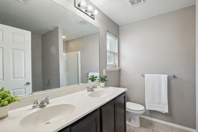 Bathroom featuring visible vents, a sink, toilet, and walk in shower | Image 26