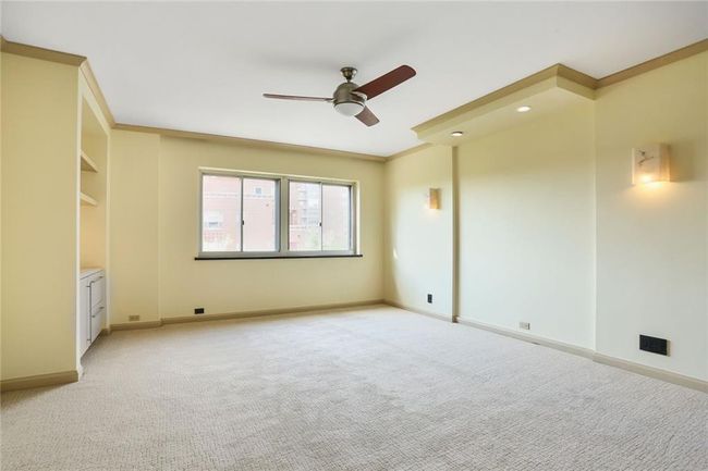 Primary bedroom with new carpet, new paint, built ins and ceiling fan | Image 9