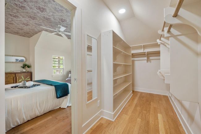 The spacious walk-in closet in the primary suite provides plenty of room for your wardrobe, with organized shelving and hanging space that makes it easy to keep everything neatly arranged and easily accessible | Image 24