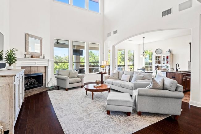 Entertain in the living room with soaring ceilings, clerestory windows and gas fireplace. | Image 4