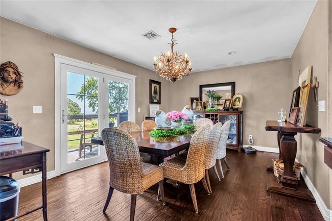 Dining area featuring a chandelier, wood finished floors, and baseboards | Image 21