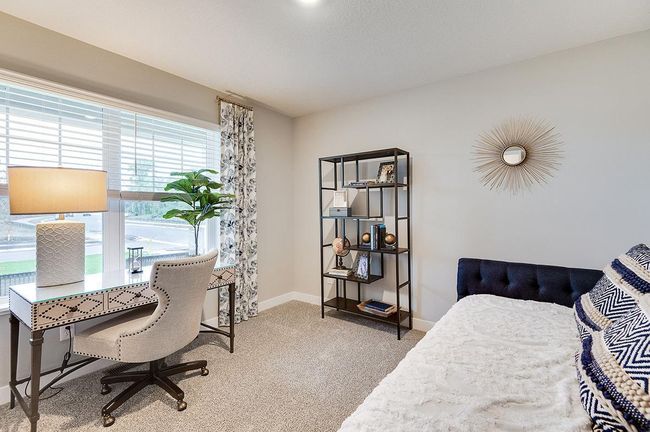 In addition to the vast living spaces on the main level, open the double doors & you are greeted by a bedroom- which can be multi-functional, & serve as a home office too, how will you use this space? Photo of model, colors and options will vary. | Image 10