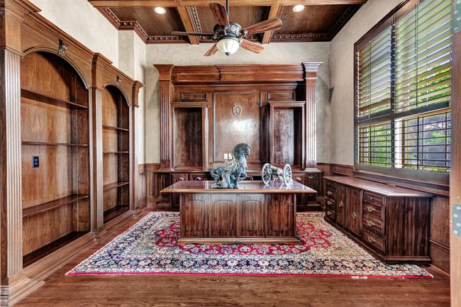 The executive office takes sophistication to a new level with the wood floor, wood accents, ornate crown molding and a coffered ceiling with carved wood details. | Image 26