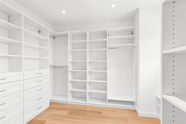 Spacious closet featuring light wood-style flooring | Image 26