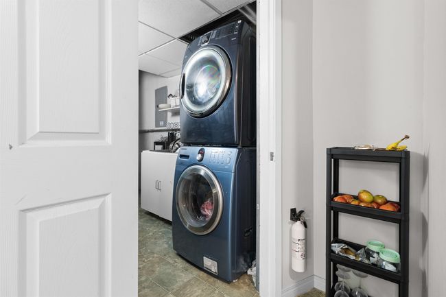 Laundry area featuring estacked washer and dryer | Image 30