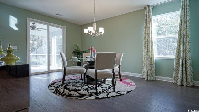 Dining area featuring plenty of natural light, wood-type flooring, baseboards, and a chandelier | Image 15