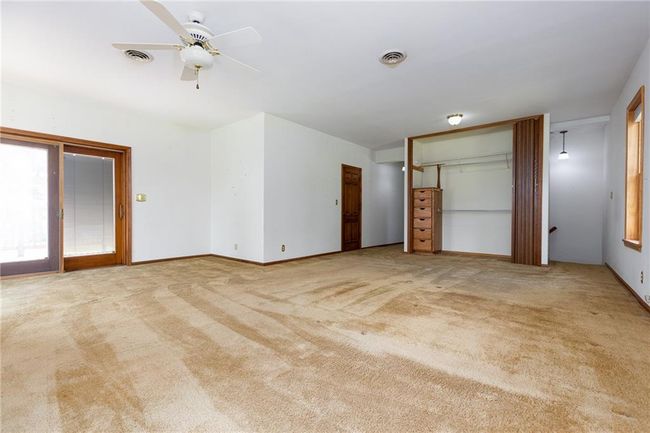 Unfurnished bedroom with light colored carpet and ceiling fan | Image 45