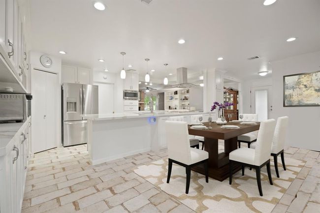 Charming breakfast area with tile flooring, fresh paint, and open into the kitchen. | Image 8