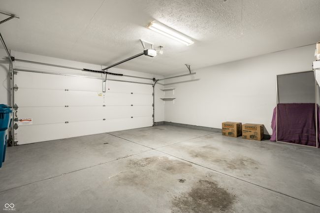 spacious garage with a garage door opener | Image 21