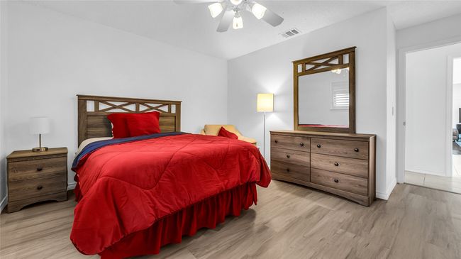Bedroom featuring wood finished floors and ceiling fan | Image 5