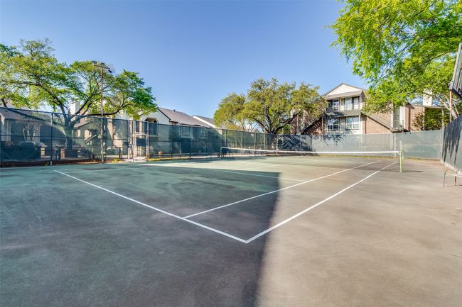 View of sport court with a residential view and fence | Image 23