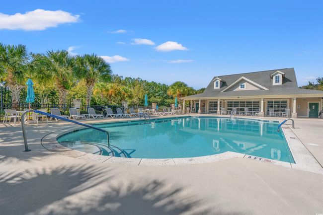 Community pool with fence and a patio area | Image 35