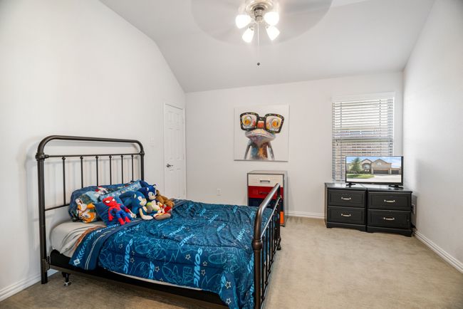 Bedroom with vaulted ceiling, light carpet, and ceiling fan | Image 28