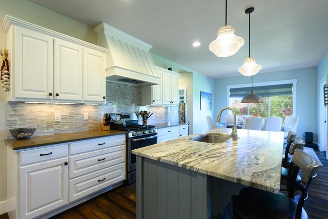 Kitchen featuring gas range, a sink, custom range hood, tasteful backsplash, and dark wood-style flooring | Image 11