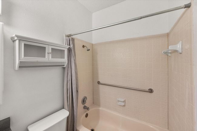 Full bath featuring toilet and shower / bath combo with shower curtain | Image 21