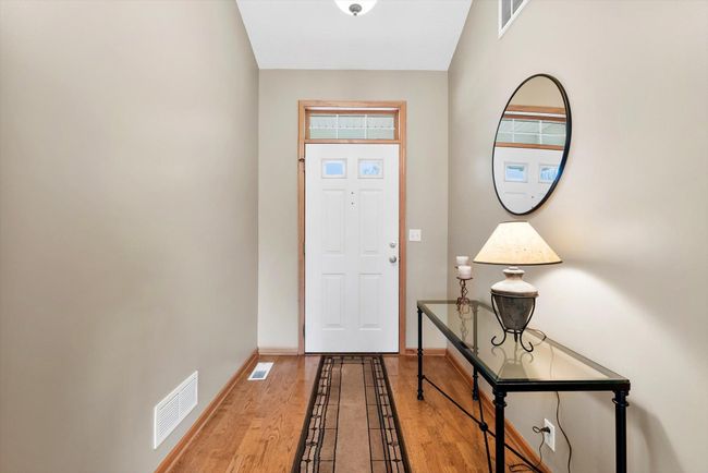 Bright and welcoming entryway with beautiful hardwood flooring that flows throughout the home. | Image 5