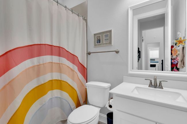Bathroom with vanity and curtained shower | Image 28