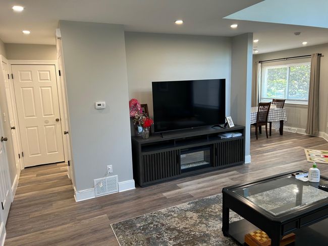 Living area with wood finished floors, baseboards, and recessed lighting | Image 17