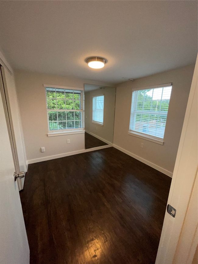 Unfurnished room featuring healthy amount of natural light, dark wood-style floors, and baseboards | Image 12