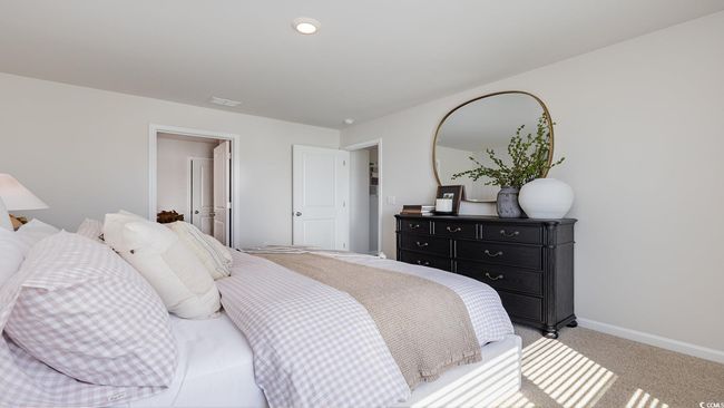 Bedroom featuring light colored carpet, baseboards, and visible vents | Image 17